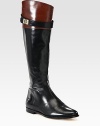 Lustrous leather in a trend-forward riding boot silhouette with a wrap-around buckle, side zipper and padded insole. Stacked heel, 1 (25mm)Shaft, 16½Leg circumference, 14½Leather upperSide zipperLeather lining and solePadded insoleImported