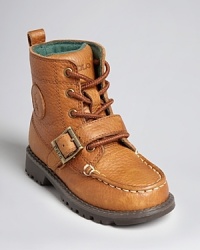 A rugged work boot is rendered in soft pebbled leather and soft fabric lining, and finished with a buckle closure above the toe. A rugged work boot is rendered in soft pebbled leather and soft fabric lining, and finished with a buckle closure above the toe.