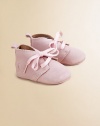 Adorable baby booties crafted in ultra-plush suede in a lace-up silhouette.Ribbon tieSuede upperLeather liningLeather solePadded insoleImported