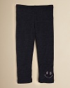 A sequin smiley face adorns the left leg of Sofi's comfy cotton leggings.