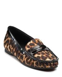 KORS Michael Kors gives penny loafers a wild makeover with leopard print microsuede and glossy trim. KORS Michael Kors gives penny loafers a wild makeover with leopard print microsuede and glossy trim.