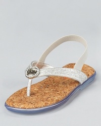 The Sindy sandal is embellished with a clear, faceted, logo-embossed rhinestones. The upper straps are rendered in a fine glitter fabric with a mirror metallic piping and an adjustable velcro strap for easy fit.