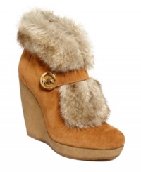 So furry and fun. MICHAEL Michael Kors' Lara platform wedge booties are decorated with a designer logo on the Mary Jane strap and a cozy and cute fluffy, faux-fur lining. So furry and fun. MICHAEL Michael Kors' Lara platform wedge booties are decorated with a designer logo on the Mary Jane strap and a cozy and cute fluffy, faux-fur lining.