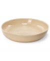 From celebrated chef and writer, Sophie Conran, comes incredibly durable dinnerware for every step of the meal, from oven to table. A ribbed texture gives this round roasting dish the charming look of traditional hand thrown pottery. Shown in white.