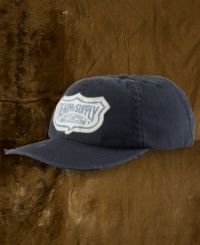 A faded baseball hat gets the signature treatment with an old-school logo and a well-worn frayed appearance. A faded baseball hat gets the signature treatment with an old-school logo and a well-worn frayed appearance.