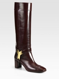 Signature gold-plated logo adorns this western-inspired leather silhouette with a stacked heel. Stacked heel, 2¼ (60mm)Shaft, 16¼Leg circumference, 14Leather upperLeather lining and solePadded insoleMade in ItalyOUR FIT MODEL RECOMMENDS ordering one half size up as this style runs small. Signature gold-plated logo adorns this western-inspired leather silhouette with a stacked heel. Stacked heel, 2¼ (60mm)Shaft, 16¼Leg circumference, 14Leather upperLeather lining and solePadded insoleMade in ItalyOUR FIT MODEL RECOMMENDS ordering one half size up as this style runs small.