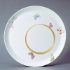 For over two centuries Raynaud has created unique Limoges porcelain, with a marked preference for relief shapes and generously colored and gilt decorations. Metamorphoses is a striking pattern of red and gold with a butterfly motif.