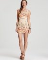 This Free People mini dress masters bohemian-luxe style with a bold floral print and metallic sheen.