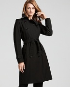 Burberry London exudes timeless chic with dramatic flair in this sleek trench coat. Pair the perennial style with all your favorite fall looks, day or night.