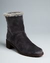 Stuart Weitzman brings plush, cozy comfort to these stylish, suede booties, in the form of faux fur trim.