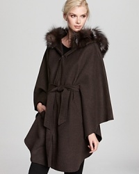 Wrap up against the chill with this sumptuous Dawn Levy cape finished with a Silver fox fur trimmed hood. Wrap up against the chill with this sumptuous Dawn Levy cape finished with a Silver fox fur trimmed hood.