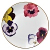 Pensees bread and butter plates by Bernardaud. This lively, luxurious collection is sure to transform your table into a celebration of spring. The floral watercolor pattern features delicate, multicolored pansies that appear to be strewn across the surface of each piece.