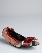 Burberry packs major style into slight ballerina flats, with a triple buckle detail and rich claret leather accents on a signature plaid backdrop.