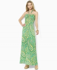A vibrant sweeping pattern enlivens Lauren by Ralph Lauren's breezy maxi dress, rendered in sleek jersey with a halter neckline. A vibrant sweeping pattern enlivens Lauren by Ralph Lauren's breezy maxi dress, rendered in sleek jersey with a halter neckline.