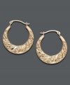 14k gold adds a glow to your look. Light up your outfit with these lovely scroll hoop earrings. Approximate diameter: 1/ inch.