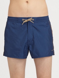 Versatile swimwear, made for plenty of summer fun, in quick-drying nylon.Drawstring elastic waistSide slash, back welt pocketsInseam, about 4PolyesterMachine washImported Versatile swimwear, made for plenty of summer fun, in quick-drying nylon.Drawstring elastic waistSide slash, back welt pocketsInseam, about 4PolyesterMachine washImported