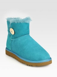 Critically acclaimed ultra-short suede design with shearling lining and an oversized side button. Suede upperShearling liningRubber solePadded insoleImported Critically acclaimed ultra-short suede design with shearling lining and an oversized side button. Suede upperShearling liningRubber solePadded insoleImported