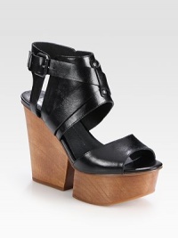 Supported by a wooden wedge and platform, this glazed leather essential has an unexpected cutout wedge, a rubber sole and adjustable criss-cross straps. Wooden wedge, 4 (100mm)Wooden platform, 1 (25mm)Compares to a 3 heel (75mm)Leather upperLeather liningRubber solePadded insoleImported