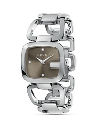 This stainless steel bracelet watch features a G bezel framing the brown sun-brushed dial, set with three diamond hour indices. This stainless steel bracelet watch features a G bezel framing the brown sun-brushed dial, set with three diamond hour indices.