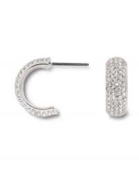 Covered in glittering pave crystals, Swarovski's huggie hoop earrings are a chic, classic look that's versatile enough to take you from the office to a night on the town! Set in silver tone mixed metal. Approximate diameter: 1/2 inch. Covered in glittering pave crystals, Swarovski's huggie hoop earrings are a chic, classic look that's versatile enough to take you from the office to a night on the town! Set in silver tone mixed metal. Approximate diameter: 1/2 inch.