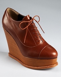 With a seamed cap toe and modern stacked wedge, Moschino Cheap and Chic's Edmonia booties lace up in smooth leather. With a seamed cap toe and modern stacked wedge, Moschino Cheap and Chic's Edmonia booties lace up in smooth leather.