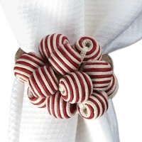 Brightly striped beads and baubles give this Juliska napkin ring a whimsical, homespun look. Brightly striped beads and baubles give this Juliska napkin ring a whimsical, homespun look.