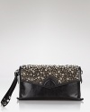 Sam Edelman's leather clutch is your perfect party companion. Toughened up with studded details, our favorite new accessory features a versatile wrist strap and enough room for the after-hours essentials.