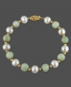 Two timeless wonders combine with grace in this 14k gold bracelet, featuring jade (8 mm) beads and cultured freshwater pearls (8 - 8-1/2 mm). Approximate length: 7-1/2 inches.