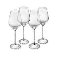 Hundreds of crystals sparkle on the stems of these glittering white wine glasses, while a faceted crystal base reflects light. From Swarovski. Hundreds of crystals sparkle on the stems of these glittering white wine glasses, while a faceted crystal base reflects light. From Swarovski.