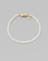 A strand of white cultured pearls with signature clasp closure.4mm white cultured pearls 18K yellow gold Length, about 7 Minuette clasp closure Imported 