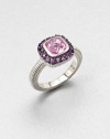 A cushion-cut pink corundum stone surrounded by pavé amethyst stones with a textured sterling silver shank. Pink corundum and amethystSterling silverWidth, about .5Imported 