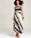 Channel seventies glamour in this striped maxi dress from Red Haute. Platform wedges and yellow gold statement bangles enhance the disco-era drama.