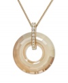 For a look that's got all the right curves. This elegant Swarovski pendant features an open-cut crystal circle with a gold tone mixed metal setting and chain. Bail accented with sparkling clear crystals. Approximate length: 15 inches. Approximate drop: 1-1/2 inches.