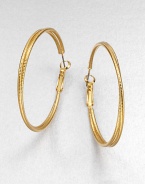 A simply chic piece with two textured rings, intertwined together in a radiant goldtone finish. GoldtoneLength, about 1.8Hinged post backImported 