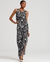 Opt for hyper-modern elegance in this floor-sweeping GUESS maxi dress, boasting a sultry snake print and thigh-high slit.