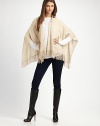 A casual style with an open drape front, warm hood and pretty fringe details in luxurious cashmere. HoodedOpen, draped frontPull-over styleFringed hemAbout 28 from back shoulder to hemCashmereDry cleanImported 