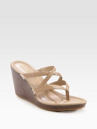 Patent leather criss-cross straps add a dose of gleam to this rustic wooden wedge. Wooden wedge, 3 (75mm)Covered platform, ½ (15mm)Compares to a 2½ heel (65mm)Patent leather upperLeather liningRubber solePadded insoleImportedOUR FIT MODEL RECOMMENDS ordering true size. Patent leather criss-cross straps add a dose of gleam to this rustic wooden wedge. Wooden wedge, 3 (75mm)Covered platform, ½ (15mm)Compares to a 2½ heel (65mm)Patent leather upperLeather liningRubber solePadded insoleImportedOUR FIT MODEL RECOMMENDS ordering true size.