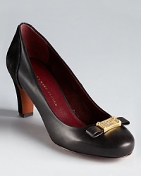 MARC BY MARC JACOBS suede backed pumps boast the brand's iconic logo plaque alongside a modern, streamlined bow. MARC BY MARC JACOBS suede backed pumps boast the brand's iconic logo plaque alongside a modern, streamlined bow.