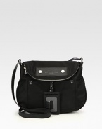 Lightweight nylon with leather accents in a soft frame with a zippered flap closure.Adjustable leather shoulder strap, 18-21 dropMagnetic snap flap closureOne zip pocket on flapOne outside open pocketRemovable leather luggage tagOne inside zip pocketTwo inside open pocketsSignature lining11½W X 11H X 3¼DImported