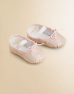 A stylish, shiny ballet flat for your tiny dancer with an elastic strap for a snug fit.Elastic strap with adjustable tiePatent leather upperLeather liningLeather solePadded insoleImported