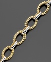 Everyday glamour with a twist. This bracelet features 14k gold over sterling silver and sterling silver smooth and twisted oval links. Approximate length: 8 inches.