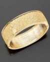 The ultimate accessory for chic downtown style: this goldtone bangle bracelet measures 2-1/4 inches in diameter.