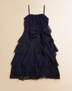 Tiers of dazzling ruffles and a simple sash tie take this classic A-line frock from elegant to extravagant.Sweetheart necklineAdjustable spaghetti strapsSide zipperBack smockingWaistband with ribbon tieFull, ruffled skirtPolyesterDry cleanImported of domestic fabric