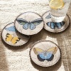 Linen coaster set by Fringe. Beautiful butterflly fabric incased in beveled glass with cork backing. Elegant beading adds to the vintage look. Set of 4 comes in gift box. Damp wipe to clean.