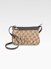Cosmetic case with interlocking G charm in GG fabric with leather trim and light goldtone hardware.Adjustable strap, 21 drop Zip-top closure Fully lined 7W X 4¾H X 1¼D Made in Italy Cosmetic case with interlocking G charm in GG fabric with leather trim and light goldtone hardware.Adjustable strap, 21 drop Zip-top closure Fully lined 7W X 4¾H X 1¼D Made in Italy