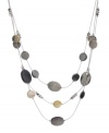 Decorate your neckline with this chic, contemporary style. Kenneth Cole New York's seashore-inspired necklace features three rows of shimmery shells. Set in silver tone mixed metal. Approximate length: 19 inches + 3-inch extender. Approximate drop: 2-1/4 inches.