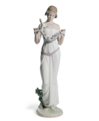 Holding a garland of pretty pink flowers, sweet Victoria brings natural beauty to any home in exquisitely handcrafted Lladro porcelain. Holding a garland of pretty pink flowers, sweet Victoria brings natural beauty to any home in exquisitely handcrafted Lladro porcelain.