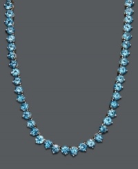 Cool down your look in icy blue hues. This vibrant necklace features a seamless row of round-cut blue topaz (45 ct. t.w.) set in sterling silver. Approximate length: 17 inches.