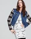 This subtly distressed Free People denim jacket boasts cozy knit sleeves for a striking two-in-one look.