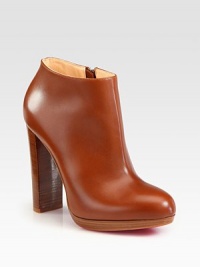 This leather design with a stacked wooden heel and platform will never go out of style. Stacked wooden heel, 4½ (115mm)Wooden platform, ½ (15mm)Compares to a 4 heel (100mm)Leather upperSide zipLeather liningSignature red leather solePadded insoleMade in ItalyOUR FIT MODEL RECOMMENDS ordering one size up as this style runs small. This leather design with a stacked wooden heel and platform will never go out of style. Stacked wooden heel, 4½ (115mm)Wooden platform, ½ (15mm)Compares to a 4 heel (100mm)Leather upperSide zipLeather liningSignature red leather solePadded insoleMade in ItalyOUR FIT MODEL RECOMMENDS ordering one size up as this style runs small.